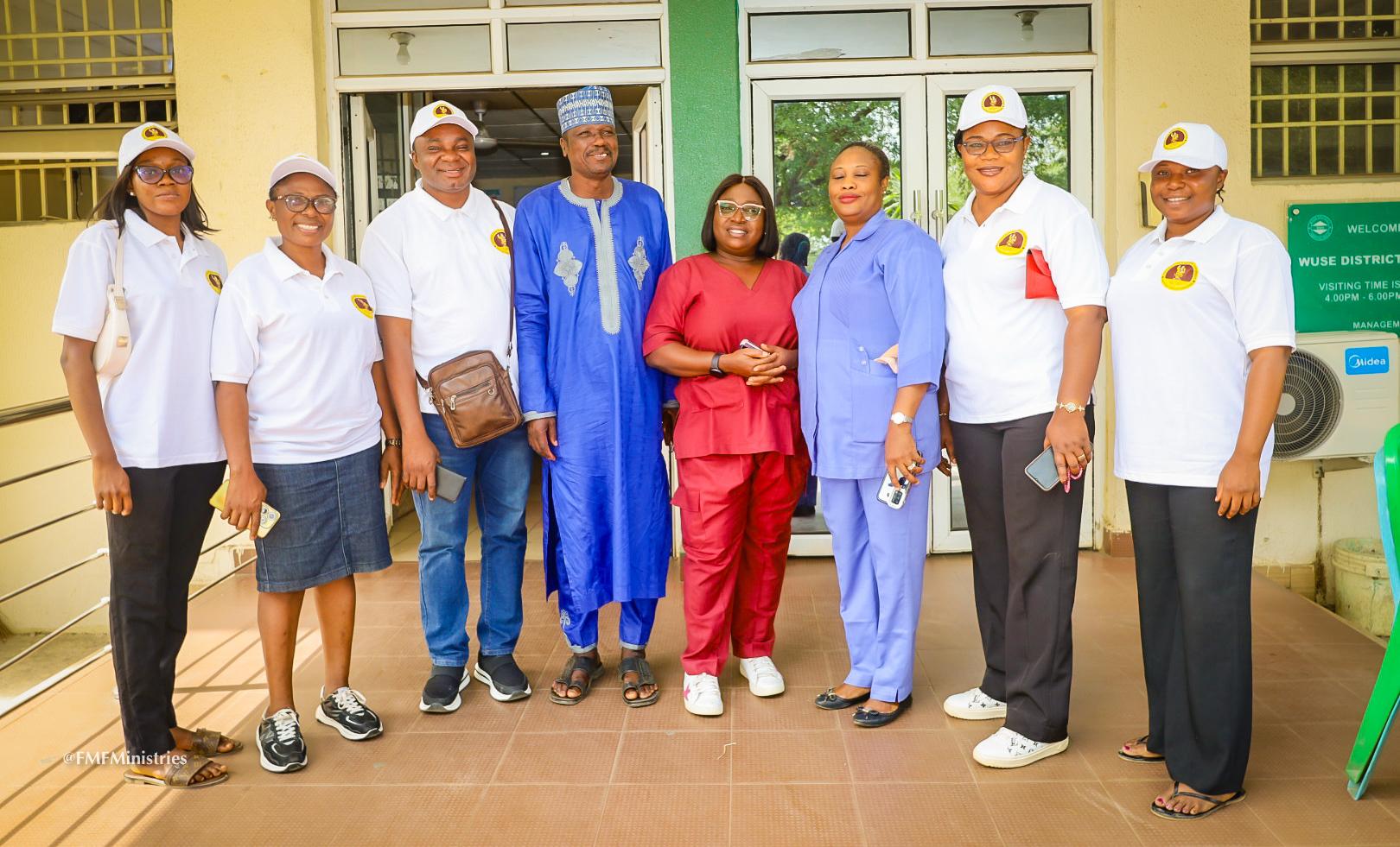The Feed my flock crew in a photo pose with the staff of general Hospital Wuse, ABUJA